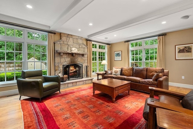 living room featuring beamed ceiling, hardwood / wood-style floors, and a fireplace