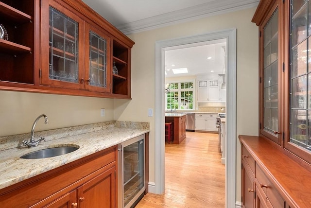 bar with dishwasher, sink, beverage cooler, ornamental molding, and light stone counters