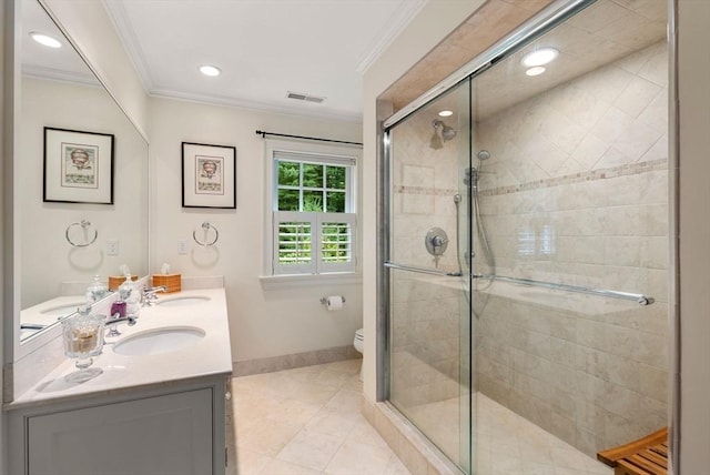 bathroom with vanity, ornamental molding, toilet, and walk in shower