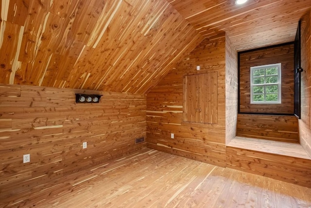 bonus room with wood-type flooring, vaulted ceiling, wooden ceiling, and wooden walls