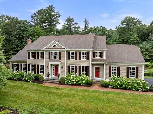 colonial inspired home with a front yard