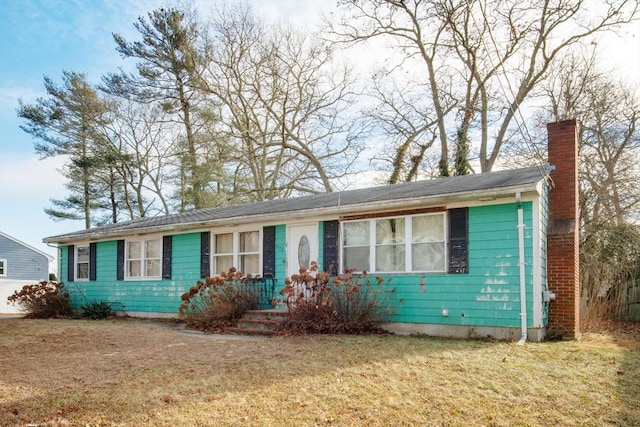 ranch-style home with a front lawn