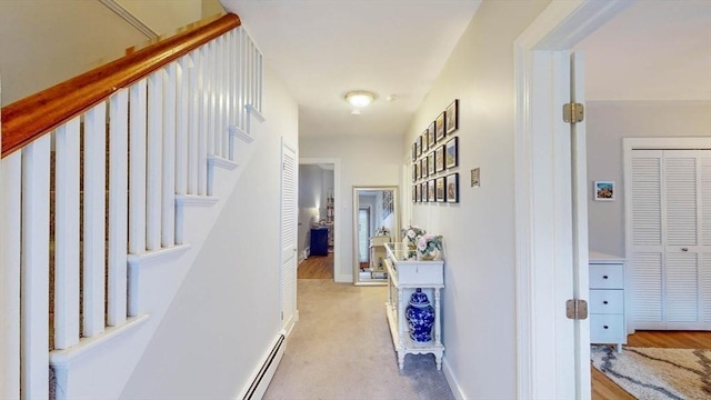 hallway with stairs and baseboards