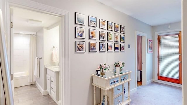 hall featuring baseboards