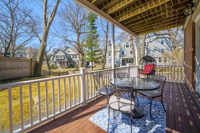 wooden deck featuring a residential view and outdoor dining space