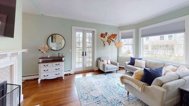 living area featuring a fireplace, french doors, crown molding, wood finished floors, and a baseboard heating unit