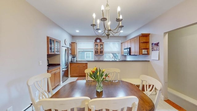 dining area featuring a chandelier, recessed lighting, and baseboards