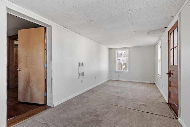 unfurnished room featuring visible vents, baseboards, carpet floors, and a paneled ceiling