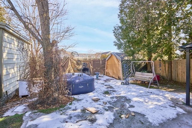 view of yard with a storage unit, an outbuilding, and fence