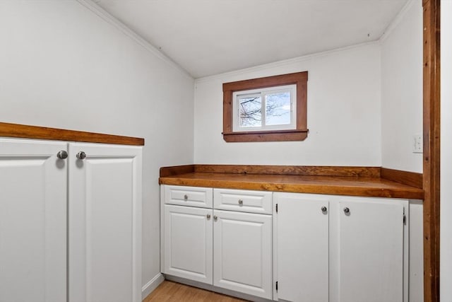 interior space featuring wood finished floors and ornamental molding