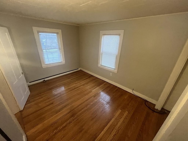 spare room featuring hardwood / wood-style flooring and a baseboard radiator