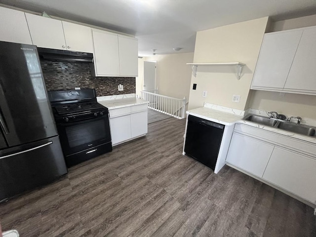 kitchen featuring white cabinets, sink, tasteful backsplash, and black appliances