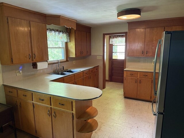 4 King Ln, Monson, MA 01057 - kitchen with freestanding refrigerator, a sink, tasteful backsplash, and plenty of natural light