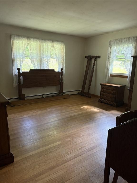 4 King Ln, Monson, MA 01057 - living area featuring wood finished floors and a baseboard radiator