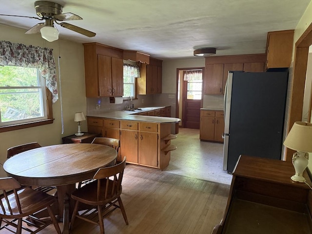 4 King Ln, Monson, MA 01057 - kitchen with freestanding refrigerator, a peninsula, a ceiling fan, and light countertops