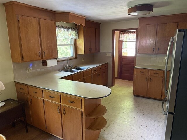 4 King Ln, Monson, MA 01057 - kitchen with freestanding refrigerator, a sink, tasteful backsplash, light countertops, and a peninsula