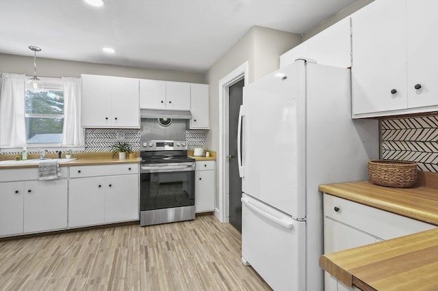 kitchen featuring stainless steel electric range oven, backsplash, freestanding refrigerator, a sink, and under cabinet range hood