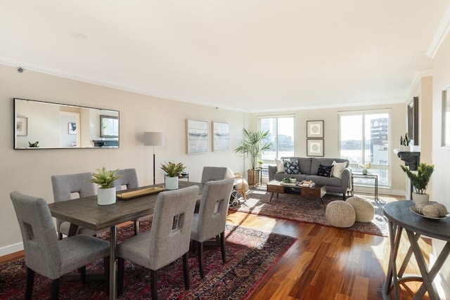 dining area with ornamental molding and wood-type flooring