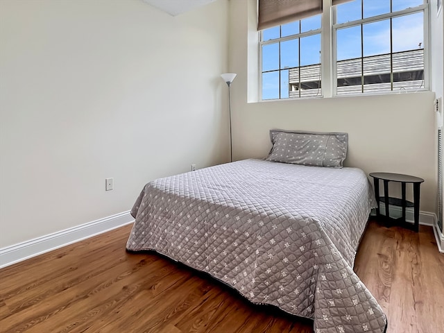 bedroom with hardwood / wood-style floors