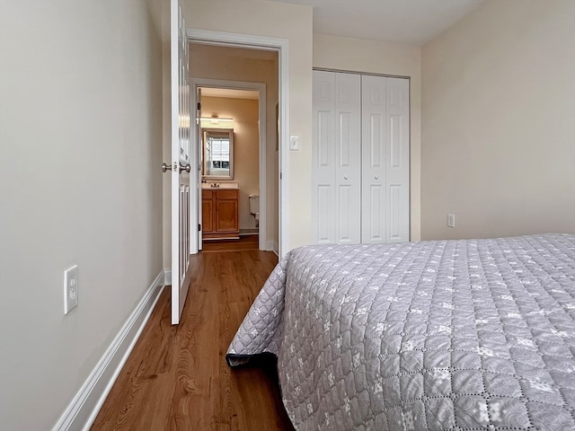 bedroom with hardwood / wood-style floors and a closet