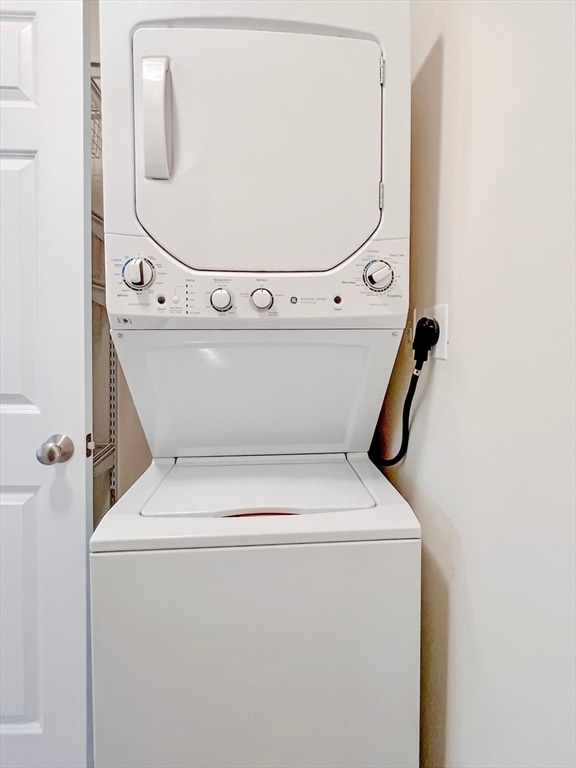 laundry area with stacked washing maching and dryer