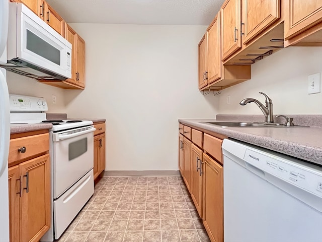 kitchen with sink and white appliances