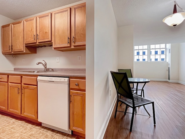 kitchen with a textured ceiling, dishwasher, light hardwood / wood-style floors, and sink