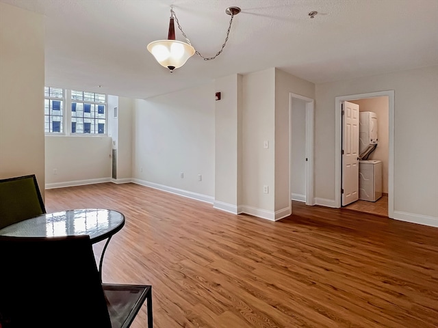 unfurnished room featuring hardwood / wood-style floors and washer / dryer