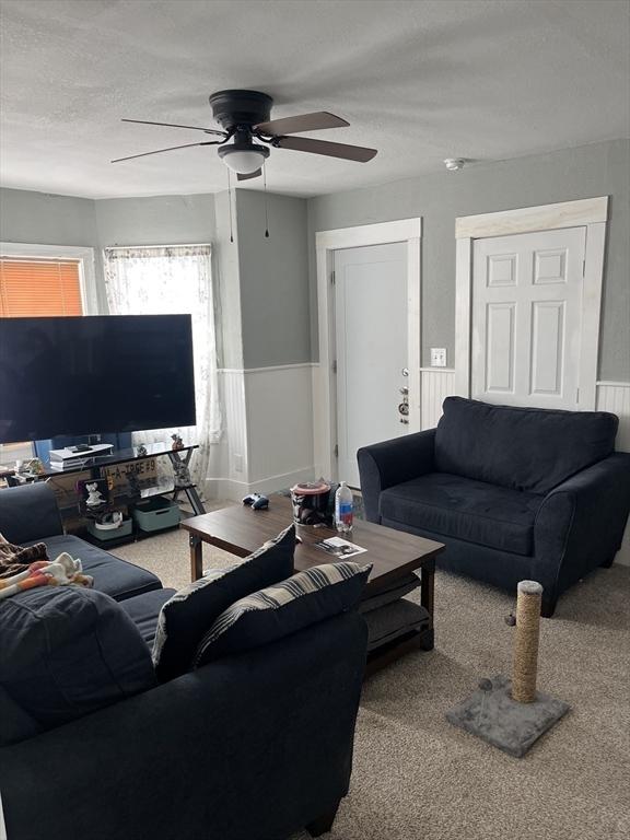 18 Dean St, Warren, MA 01083 - carpeted living area with wainscoting and ceiling fan