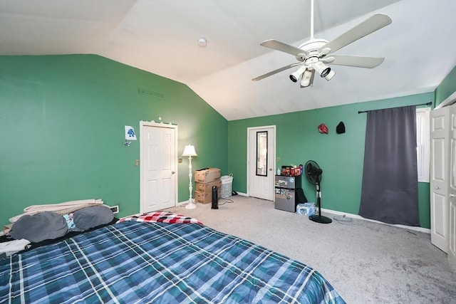 carpeted bedroom with ceiling fan and vaulted ceiling