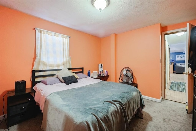 bedroom featuring a textured ceiling and carpet