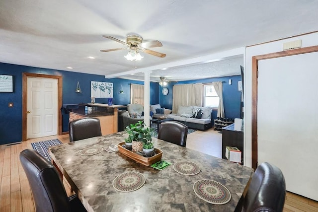 dining area with light hardwood / wood-style flooring and ceiling fan