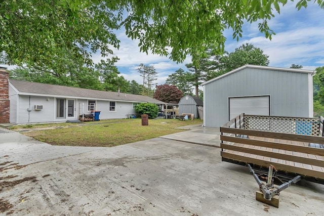 42 Charlotte Furnace Rd, Wareham, MA 02576 - rear view of property with an outbuilding, a detached garage, a yard, and concrete driveway