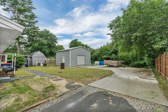 42 Charlotte Furnace Rd, Wareham, MA 02576 - view of yard featuring a detached garage, driveway, a patio, and a storage shed