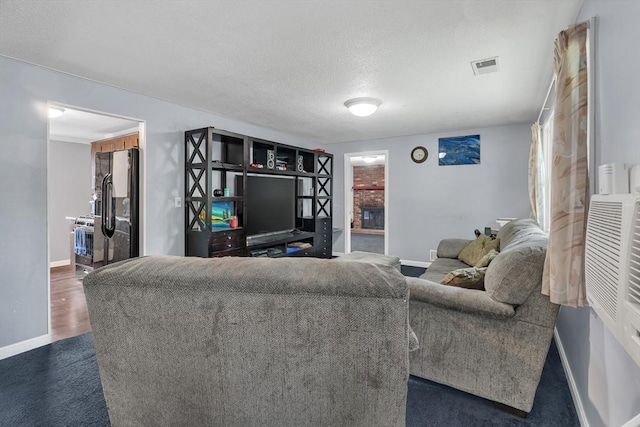 42 Charlotte Furnace Rd, Wareham, MA 02576 - living room featuring a fireplace and a textured ceiling