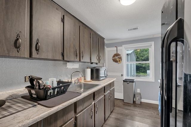 42 Charlotte Furnace Rd, Wareham, MA 02576 - kitchen featuring stainless steel microwave, dark wood-style flooring, light countertops, a textured ceiling, and dark brown cabinetry