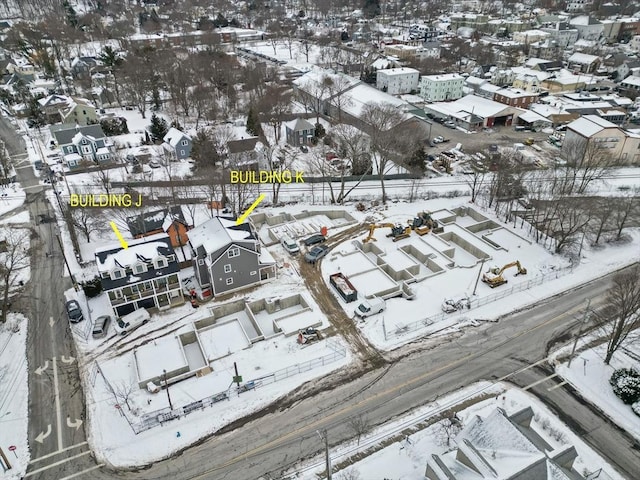 snowy aerial view featuring a residential view