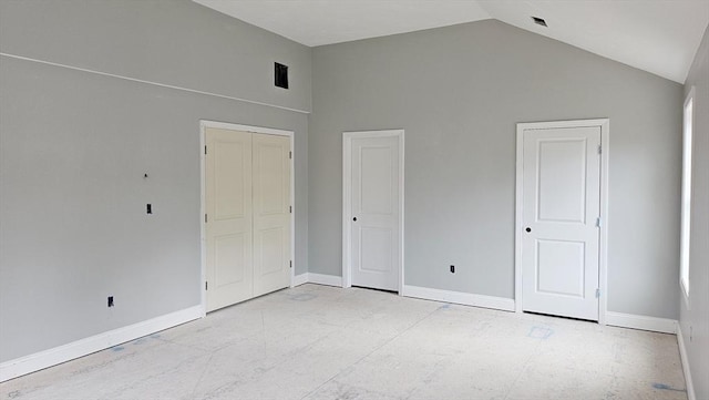 unfurnished bedroom with high vaulted ceiling