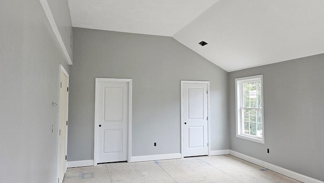 unfurnished bedroom with vaulted ceiling