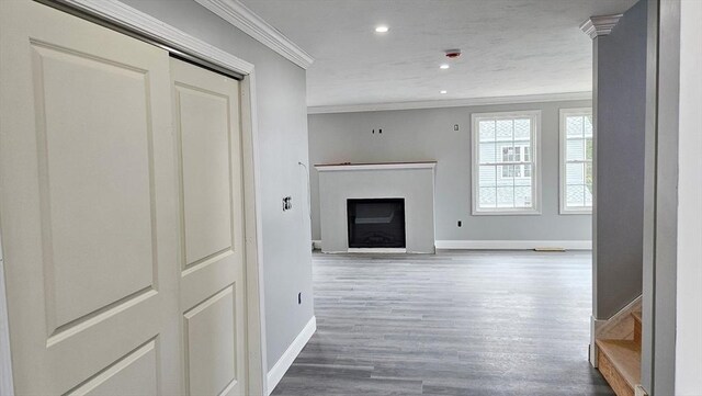 living room with hardwood / wood-style flooring and crown molding