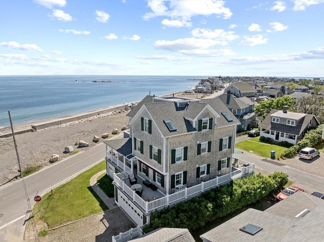 birds eye view of property with a water view and a view of the beach