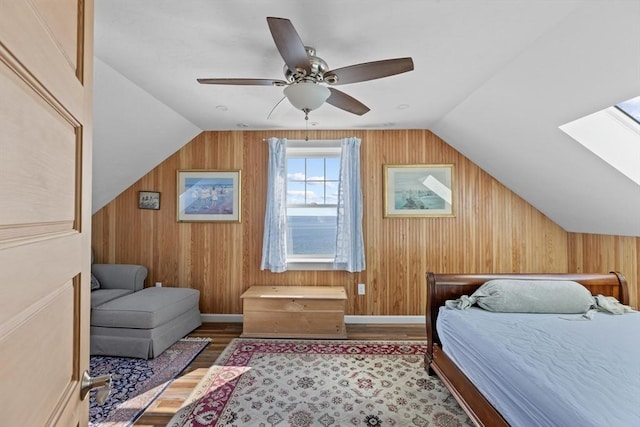 bedroom with ceiling fan, lofted ceiling, and light wood-type flooring