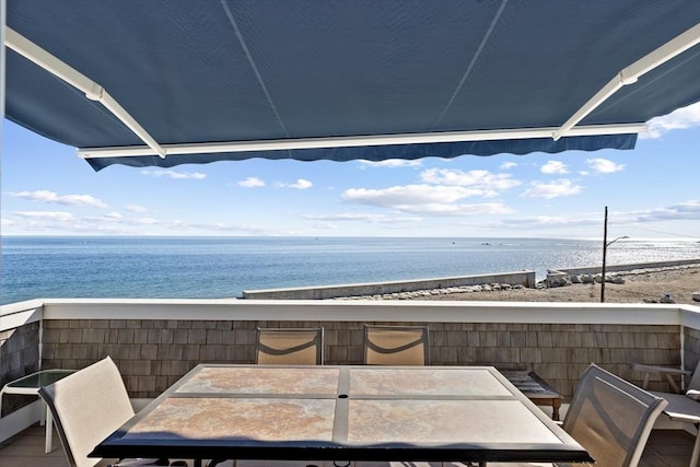 balcony with a water view and a beach view