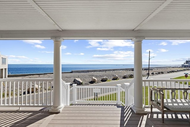 deck featuring a water view and a view of the beach