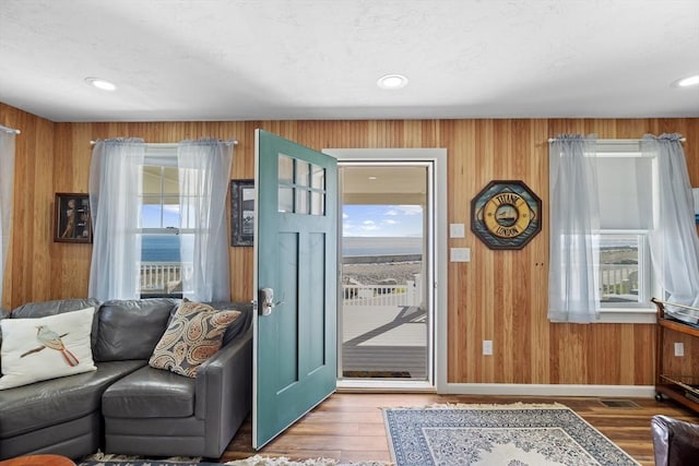 doorway with wood-type flooring and wood walls