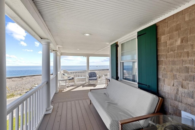 balcony featuring a water view and a view of the beach