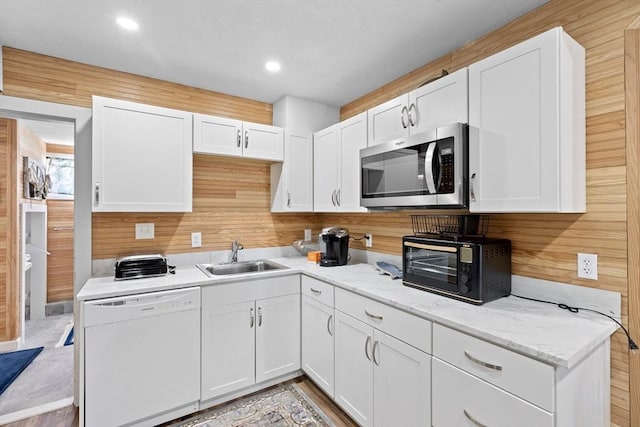 kitchen featuring sink, white cabinetry, and dishwasher