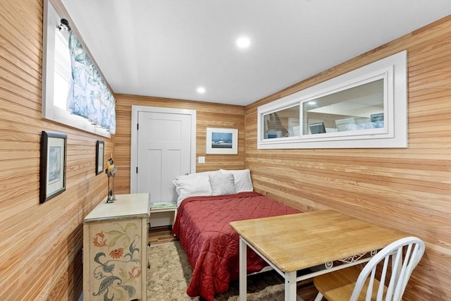 bedroom featuring wood walls