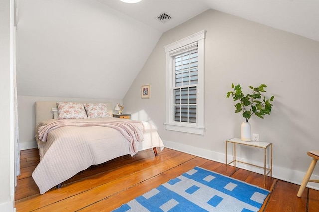 bedroom with dark hardwood / wood-style floors and vaulted ceiling