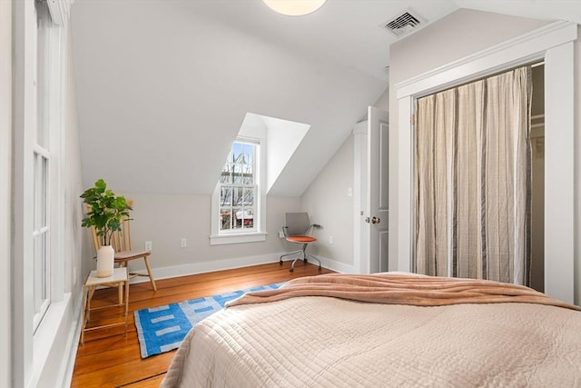 bedroom featuring lofted ceiling and wood-type flooring